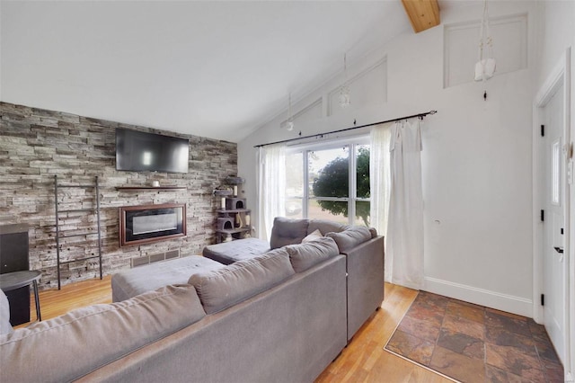 living room with beam ceiling, hardwood / wood-style flooring, a fireplace, and high vaulted ceiling