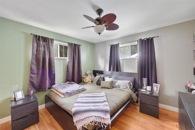 bedroom with ceiling fan and light wood-type flooring