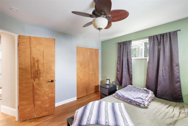 bedroom with light hardwood / wood-style floors and ceiling fan