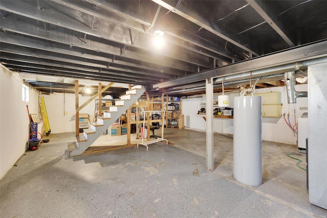 basement featuring water heater and washer / clothes dryer