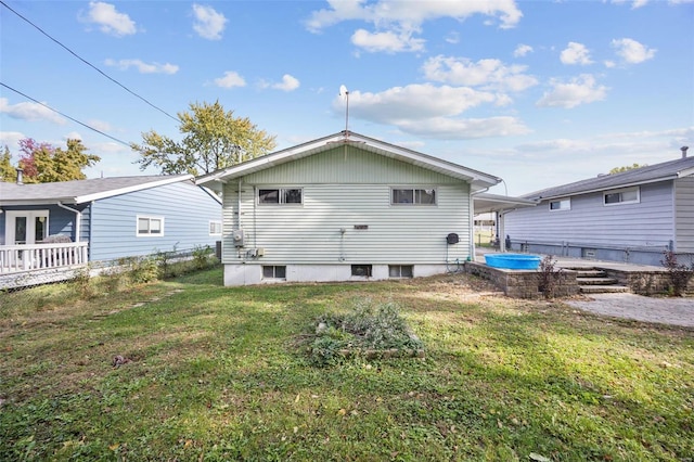 rear view of house featuring a yard