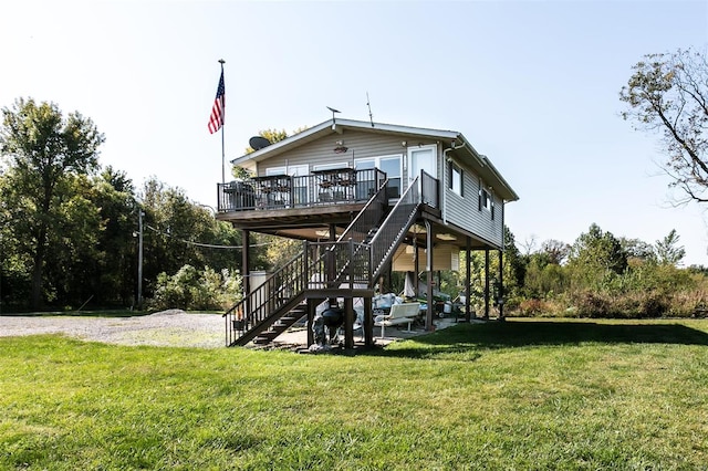 rear view of property with a wooden deck, a yard, and a patio