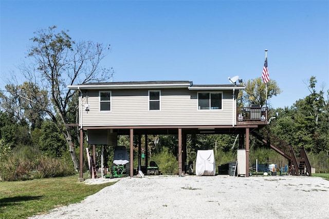 view of front of property with a front lawn and a carport