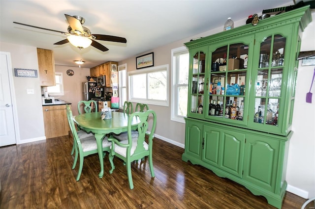 dining room with dark hardwood / wood-style flooring and ceiling fan