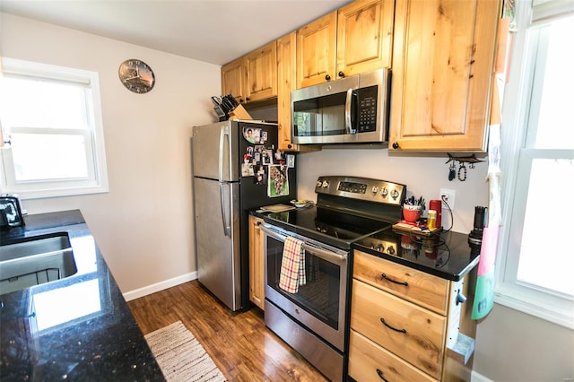 kitchen with dark wood-type flooring, light brown cabinets, appliances with stainless steel finishes, and sink