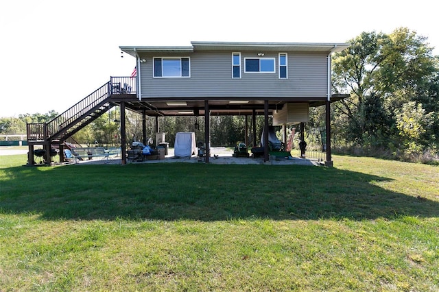 back of house with a patio and a lawn