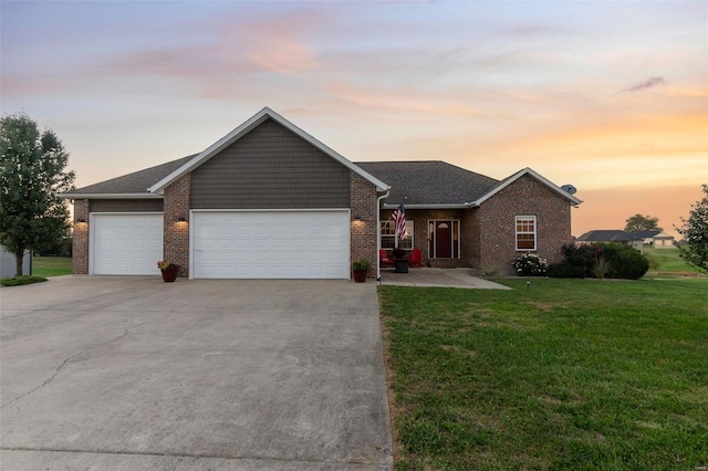 ranch-style home featuring a garage, concrete driveway, brick siding, and a front lawn