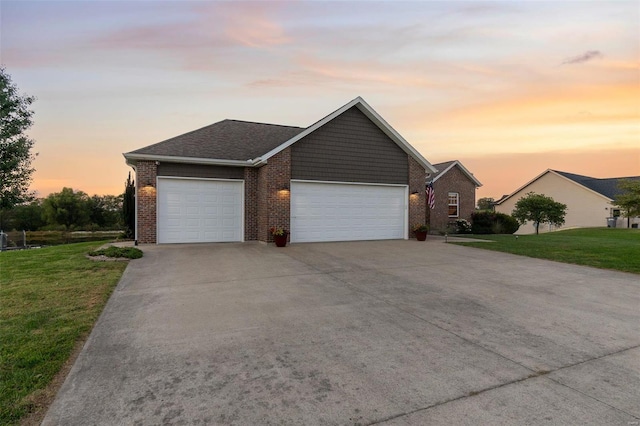 ranch-style house with driveway, brick siding, a lawn, and an attached garage