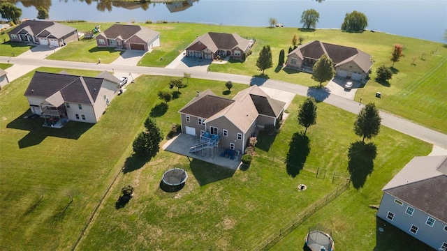 drone / aerial view with a water view and a residential view