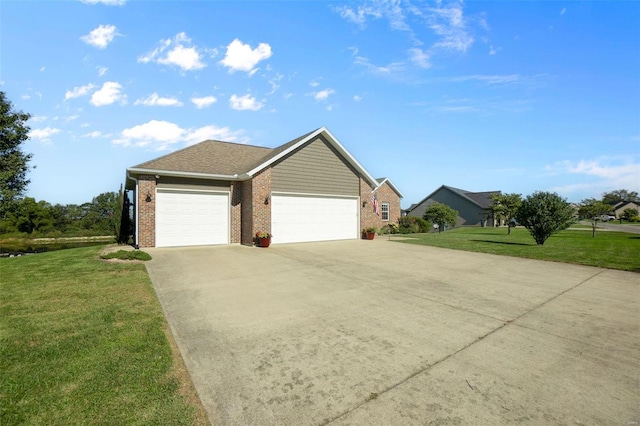 view of front of house with a garage, a front lawn, concrete driveway, and brick siding