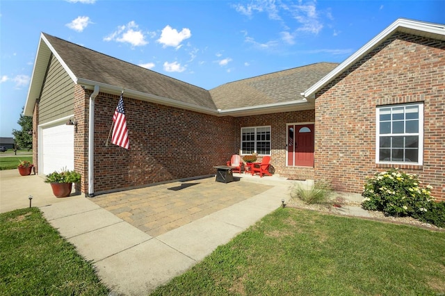 view of front of property with a garage, entry steps, brick siding, roof with shingles, and a front yard