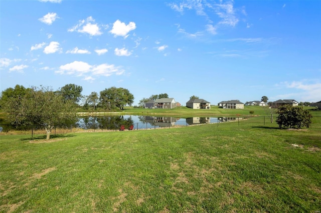 view of yard featuring a water view and fence