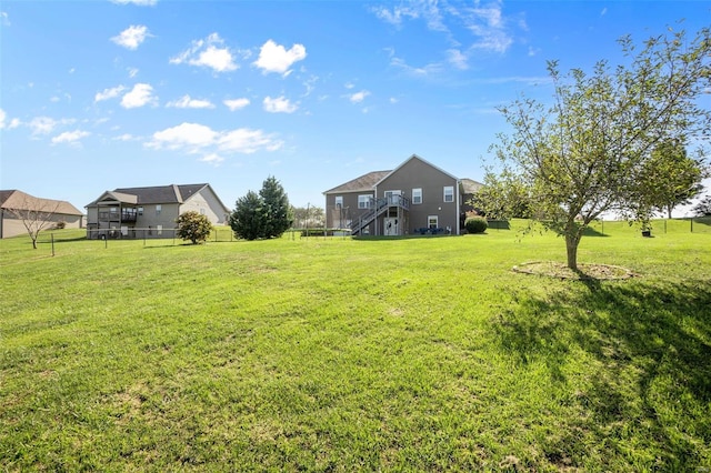 view of yard featuring fence and stairway