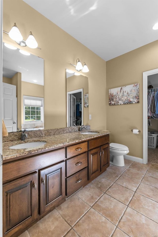 bathroom featuring tile patterned floors, vanity, and toilet