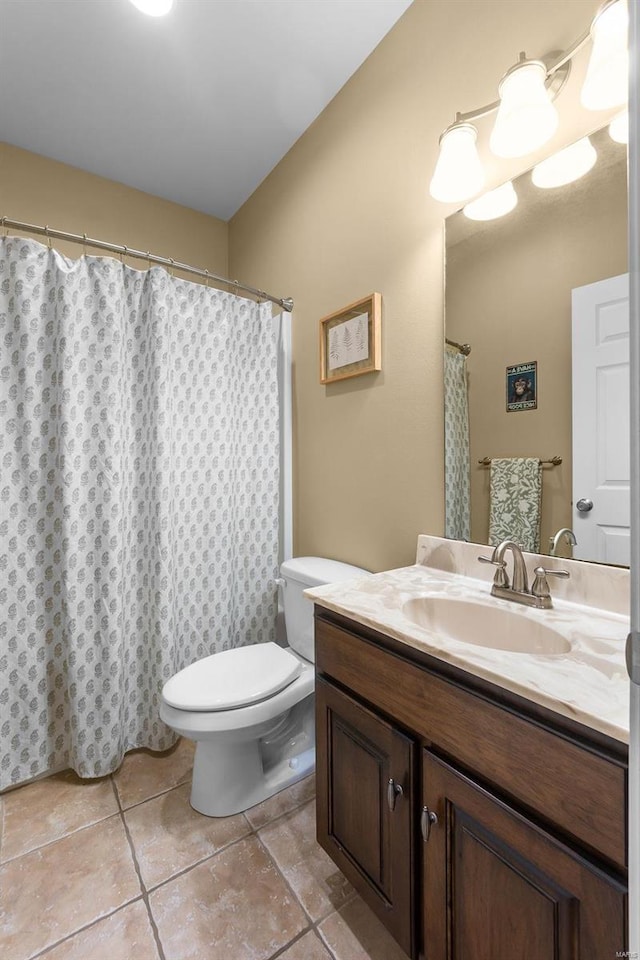 bathroom featuring tile patterned floors, vanity, and toilet