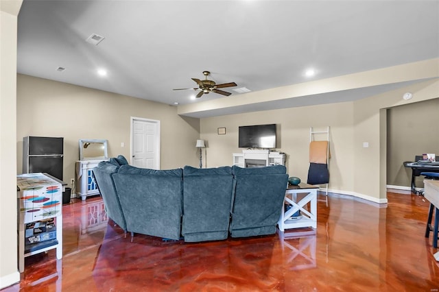 living room featuring ceiling fan and concrete floors