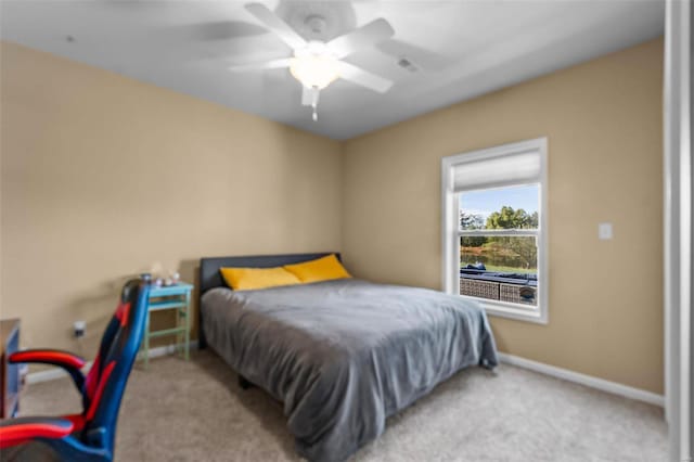 bedroom featuring light carpet and ceiling fan