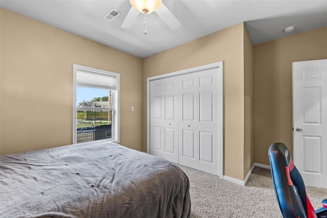 bedroom featuring ceiling fan, a closet, and light colored carpet