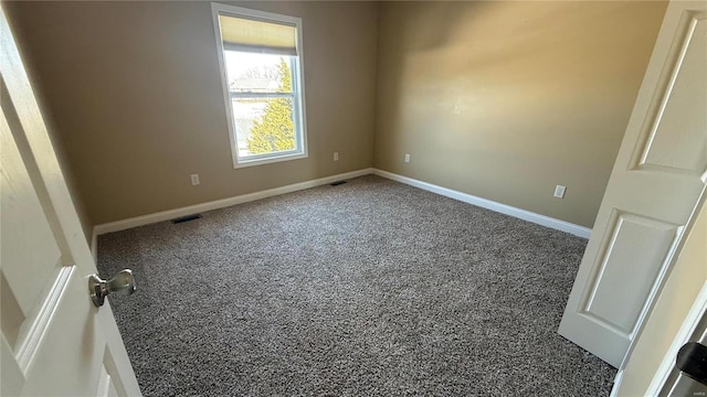 unfurnished room featuring visible vents and baseboards