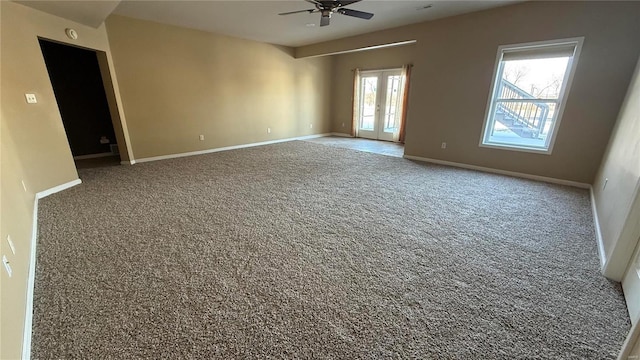 spare room with a ceiling fan, baseboards, carpet flooring, and french doors