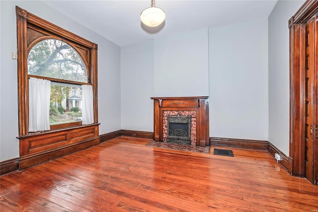 unfurnished living room with wood-type flooring