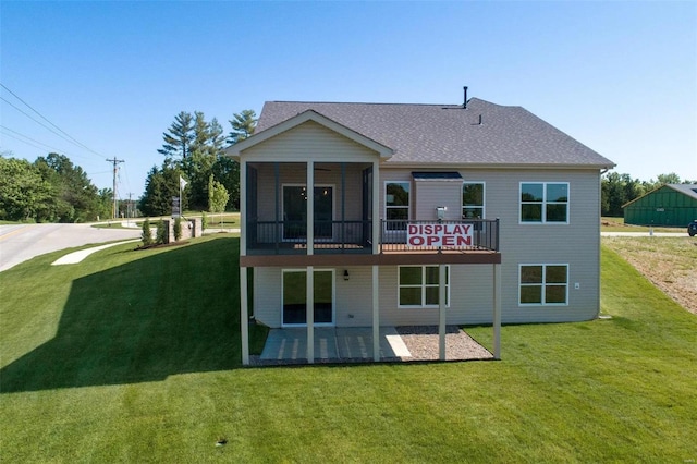 rear view of property featuring a patio and a lawn