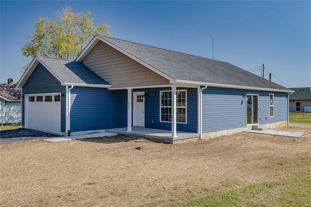 view of front of house featuring a front yard and a garage