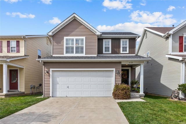 view of front of property featuring a front yard and a garage