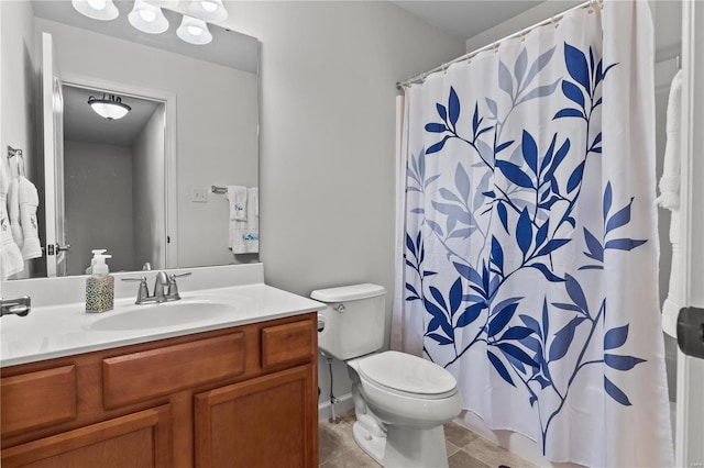 bathroom with tile patterned flooring, vanity, and toilet