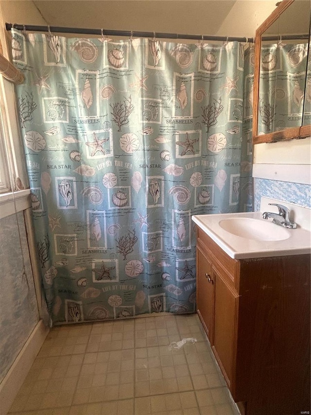 bathroom featuring walk in shower, vanity, and tile patterned flooring