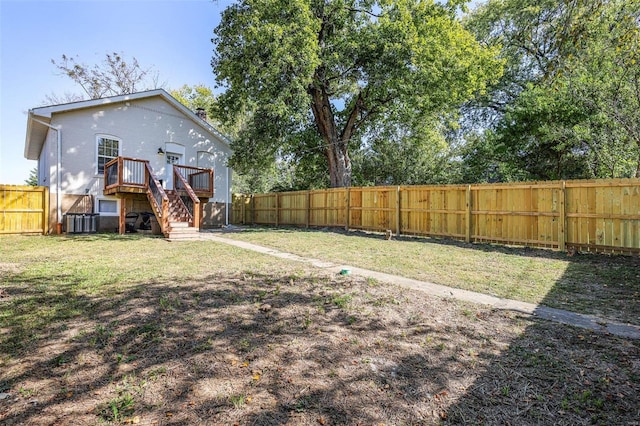 view of yard featuring central AC unit and a wooden deck