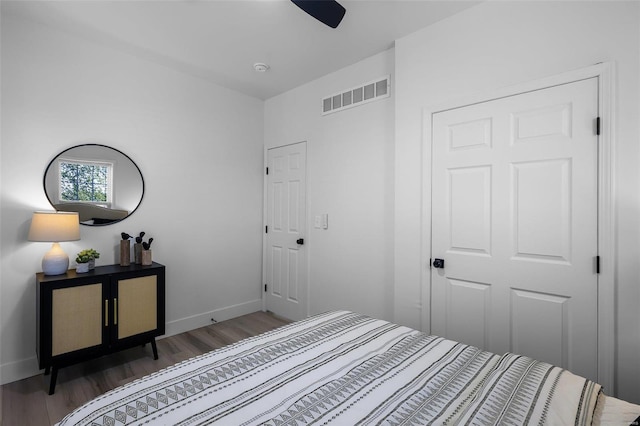 bedroom with dark hardwood / wood-style flooring