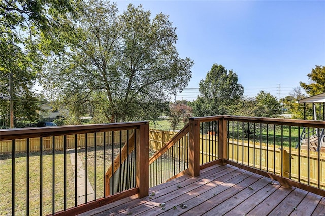 wooden terrace with a lawn