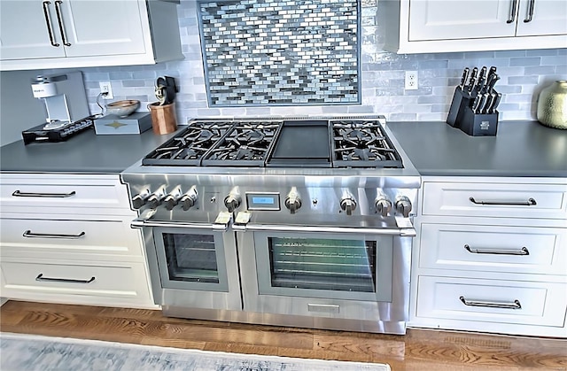 kitchen featuring double oven range and white cabinetry