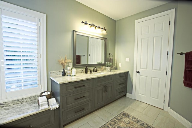 bathroom with tile patterned flooring, vanity, and baseboards