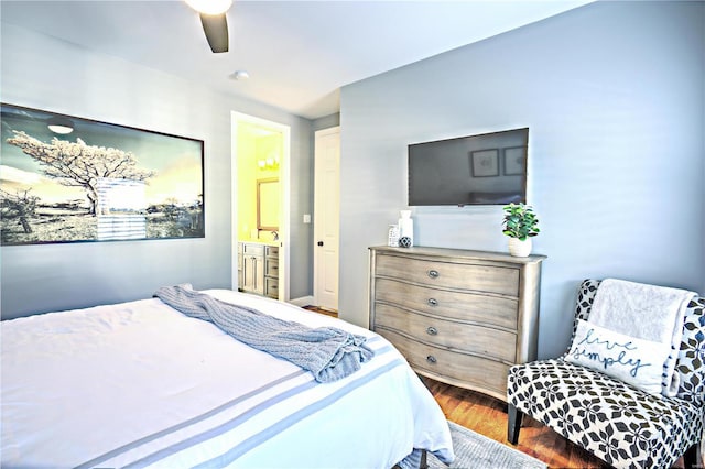 bedroom featuring ceiling fan, connected bathroom, and wood finished floors