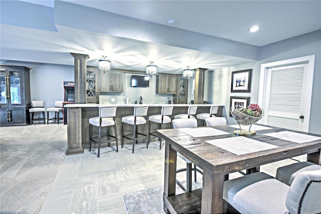 dining area with recessed lighting, light carpet, and ornate columns