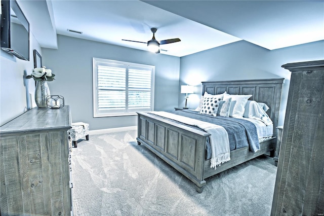 bedroom with a ceiling fan, light carpet, visible vents, and baseboards