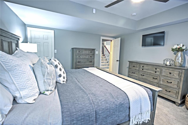 bedroom with ceiling fan and light colored carpet