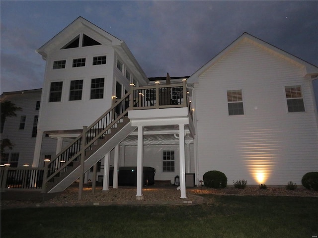 rear view of house with stairway and a deck