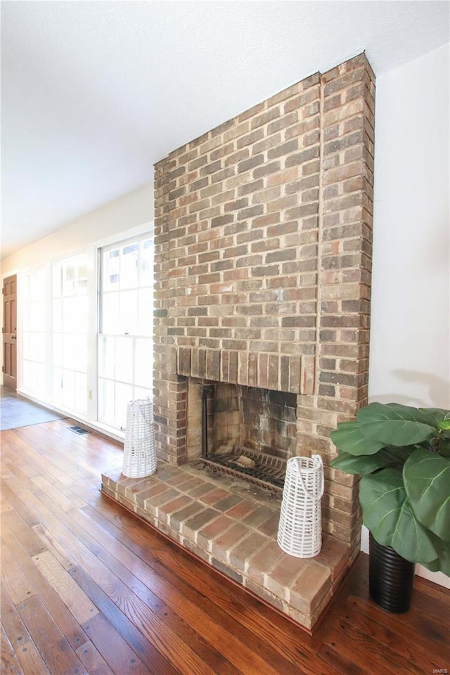 room details featuring a fireplace and hardwood / wood-style floors