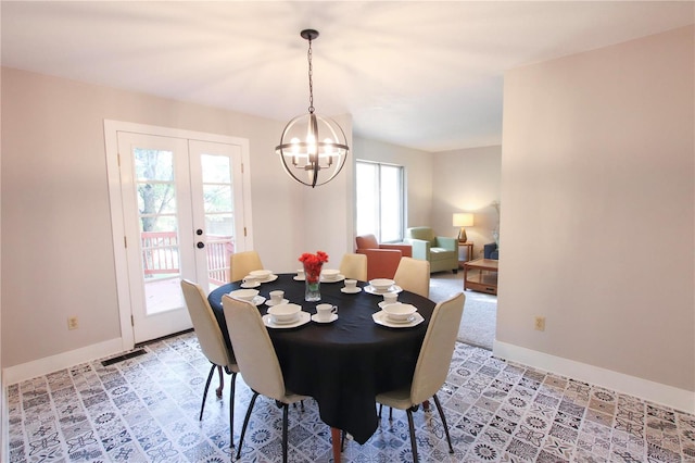 dining space with french doors, a chandelier, and a wealth of natural light