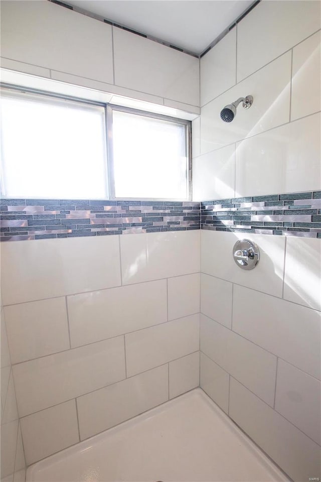 bathroom with tiled shower