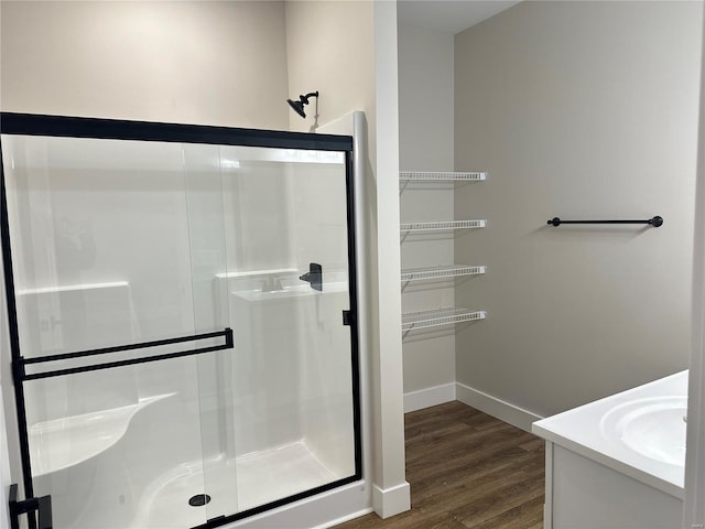 bathroom featuring vanity, an enclosed shower, and wood-type flooring