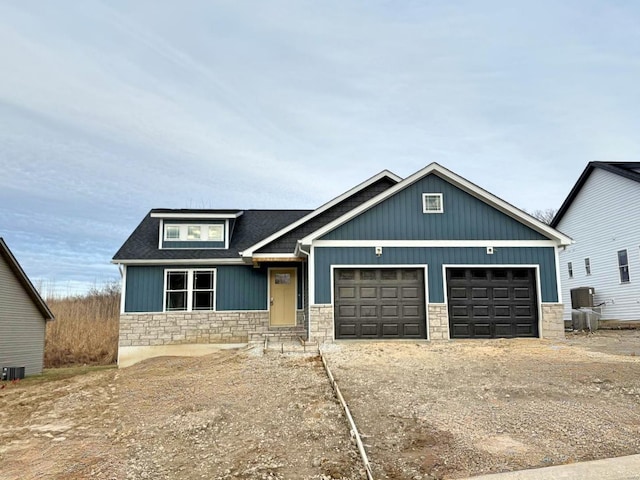 craftsman-style home featuring central AC and a garage