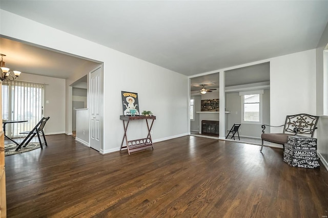 living area featuring dark hardwood / wood-style flooring and an inviting chandelier