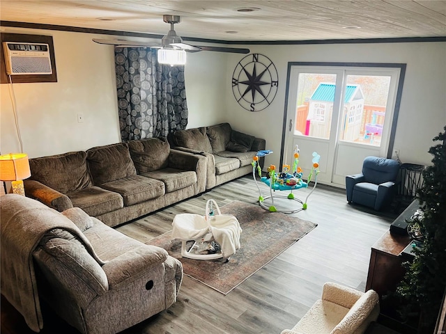 living room with ceiling fan, light wood-type flooring, and an AC wall unit