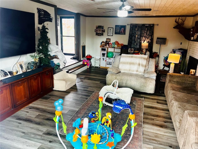 living room with hardwood / wood-style floors, crown molding, ceiling fan, and wooden ceiling