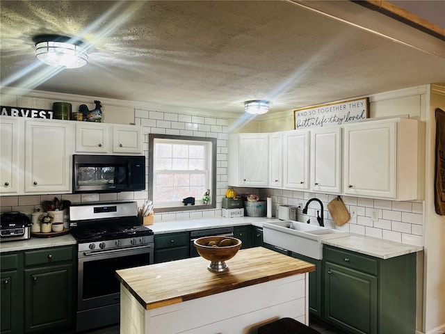 kitchen featuring tasteful backsplash, a textured ceiling, sink, black appliances, and white cabinetry