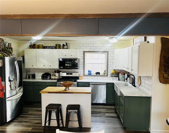 kitchen with white cabinetry, stainless steel appliances, wood counters, dark hardwood / wood-style floors, and backsplash